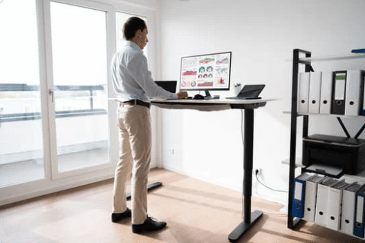 standing man in front of a high desk